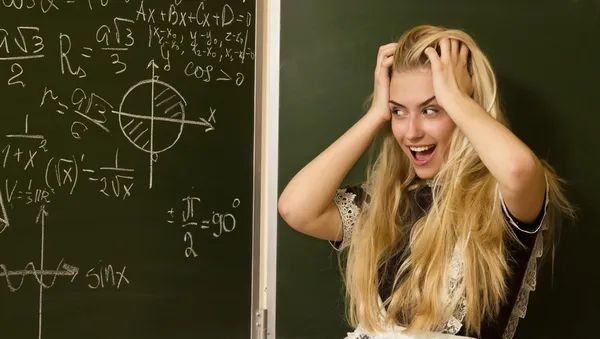 Happy school girl on math classes finding solution — Stock Photo, Image