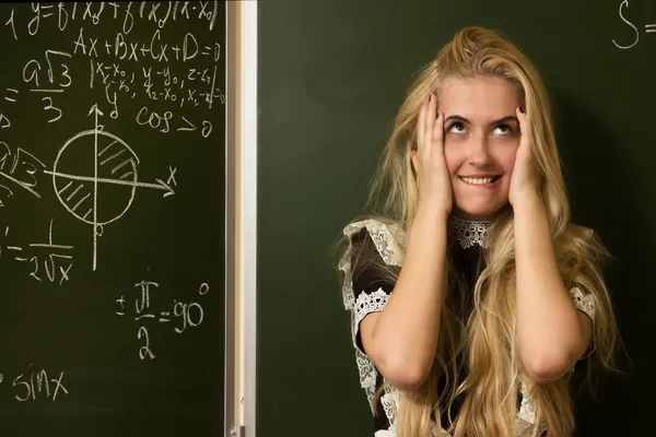 Happy school girl on math classes finding solution — Stock Photo, Image