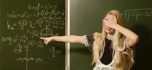 Pretty school girl on math classes finding solution — Stock Photo, Image