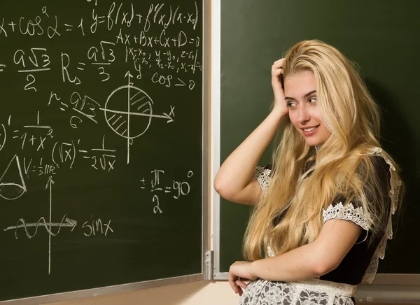 Happy school girl on math classes finding solution Royalty Free Stock Photos