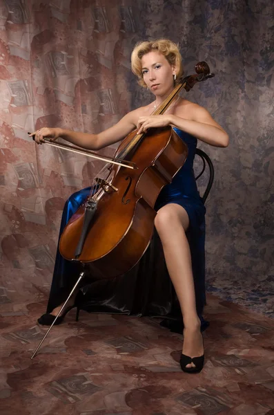 Woman in evening dress playing cello — Stock Photo, Image