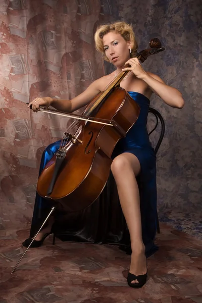 Woman in evening dress playing cello — Stock Photo, Image