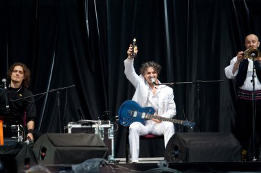 Lviv - May 22: Goran Bregovic drinks beer clipart