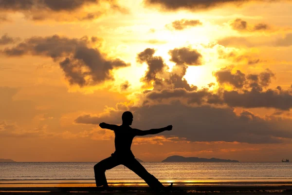Мужской силуэт делает упражнения для йоги лучник — стоковое фото