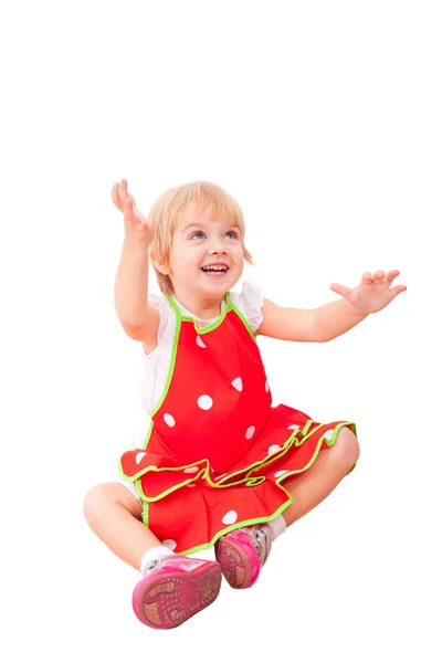 Cheerful little girl in red apron — Stock Photo, Image