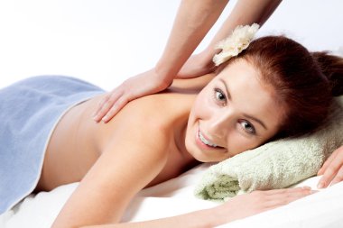 Young woman enjoyng a massage clipart