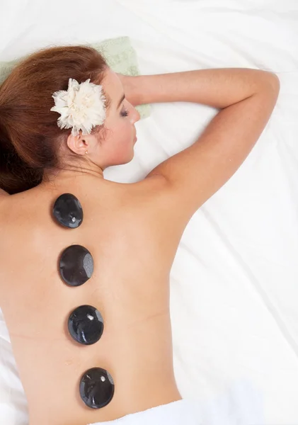 Frau bekommt Massage mit heißem Stein. — Stockfoto