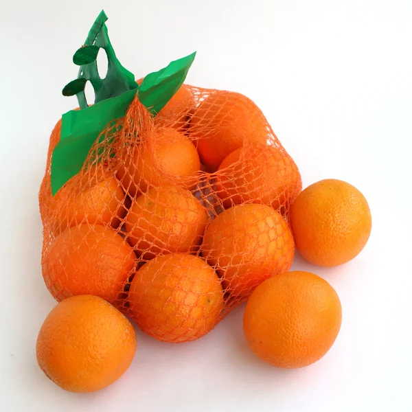 Two kilograms of oranges in the grid. — Stock Photo, Image