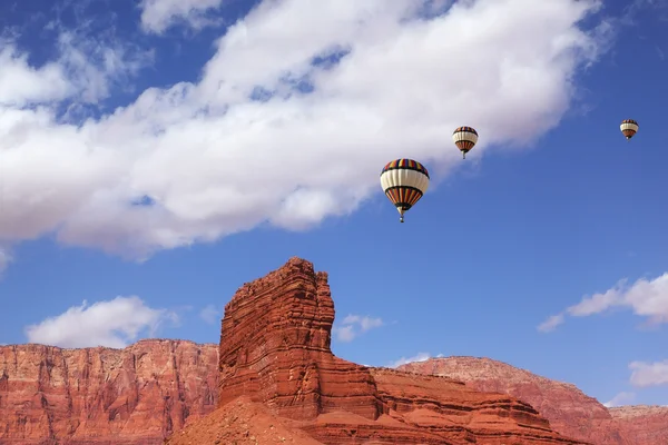 Huge balloons flying over cliffs