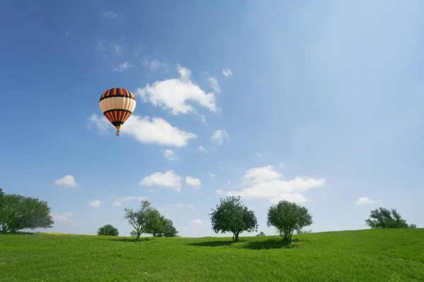 Huge balloon above meadows