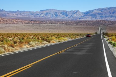 The red car traveling on the road clipart