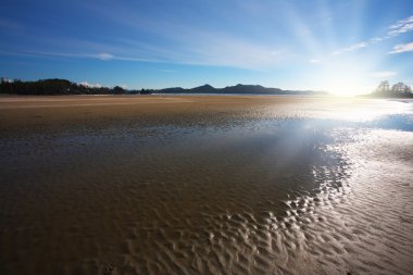 Low tide at sunset clipart