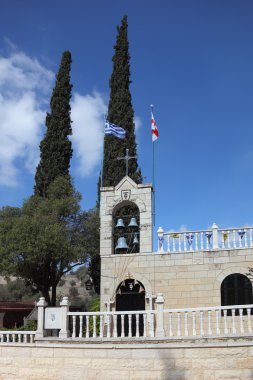 The bell tower, topped by a cross clipart