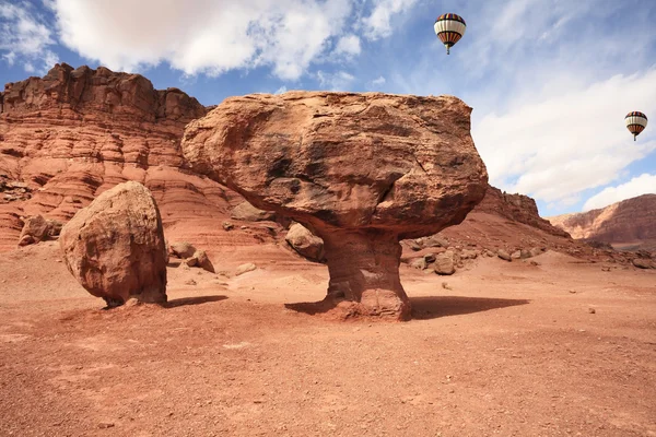 stock image The red monoliths, fly over them colorful balloons