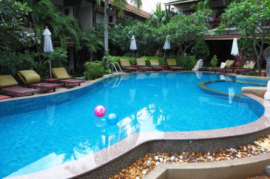 Two inflatable balls in pool with the transparent water clipart