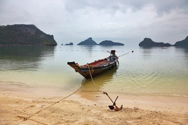 Thai Longtail boat moored on a sandy beach