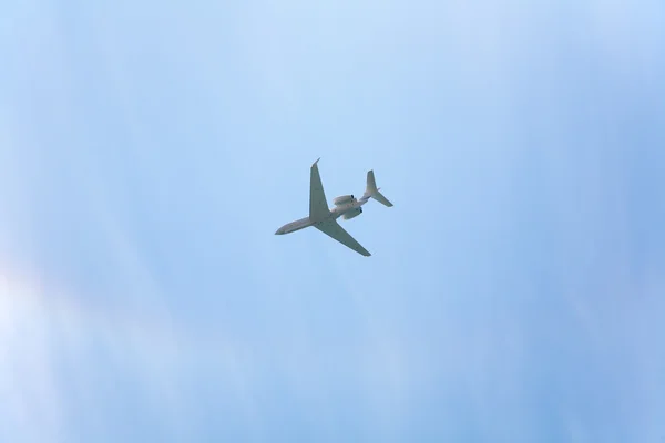 Plane in the cloudy sky — Stock Photo, Image
