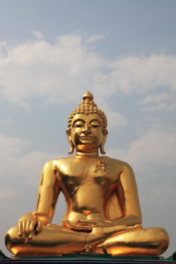 The huge Golden Buddha shines in the sun clipart