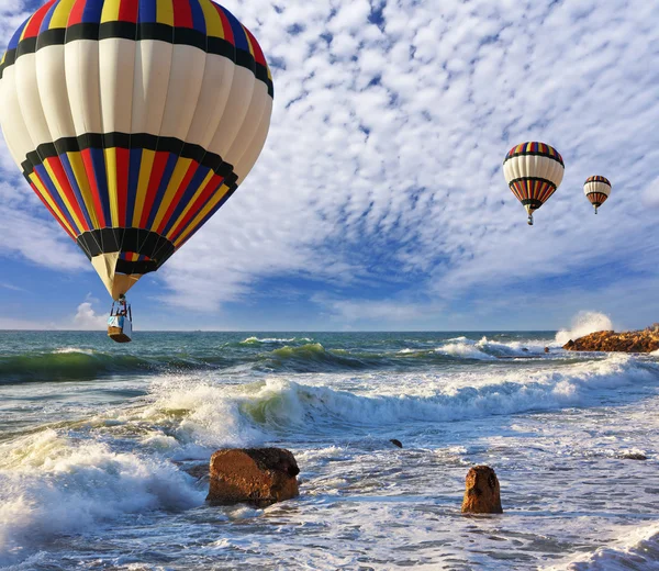 Huge balloons, sea, a spring storm
