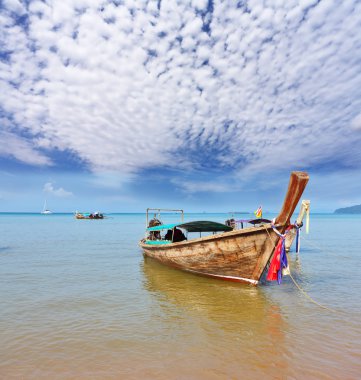 A decorated native boat Longtail has dropped an anchor clipart