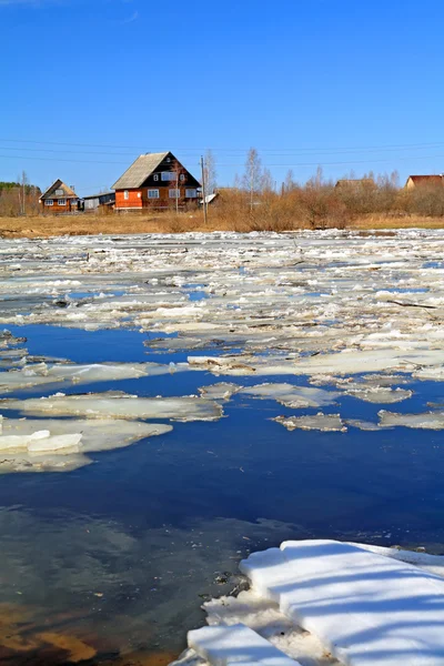 Řízení ledu na řece poblíž vesnice — Stock fotografie