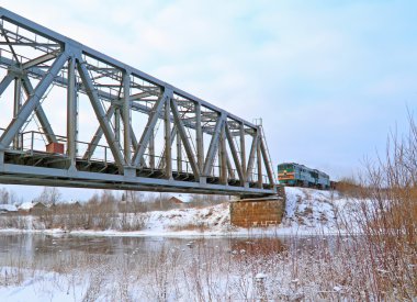 Train on bridge through river clipart