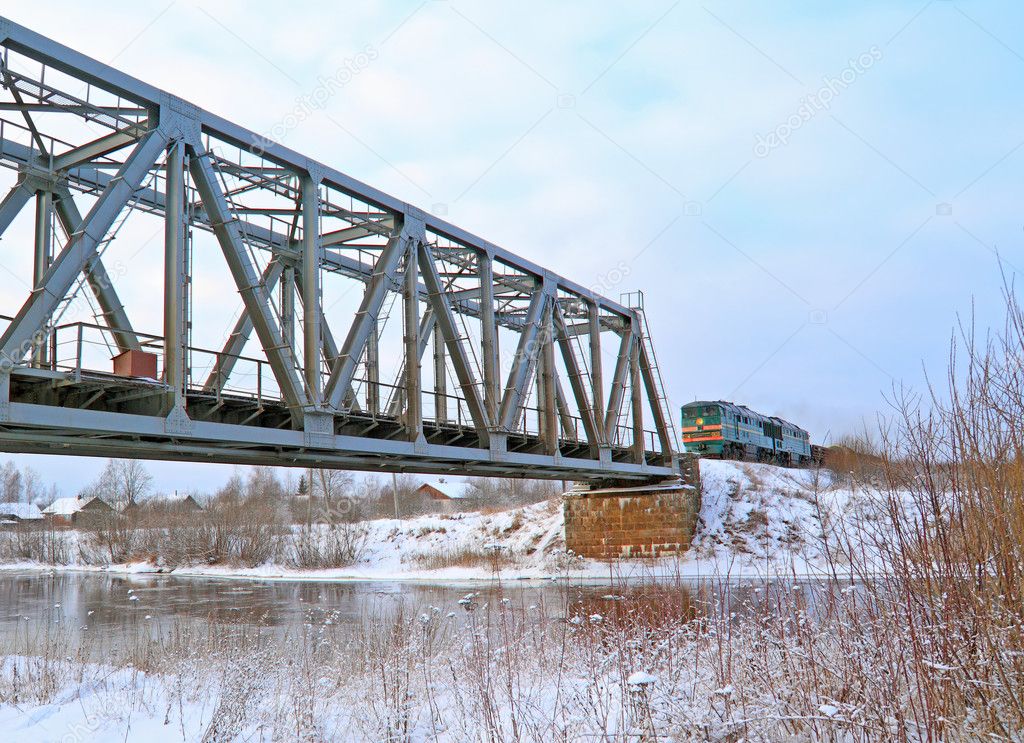 Train on bridge through river