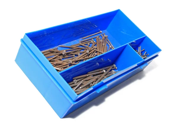 Hřebík v modrém plastovém boxu — Stock fotografie