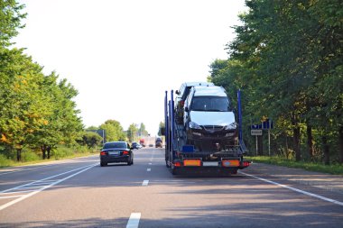 Cargo cars on asphalt road clipart