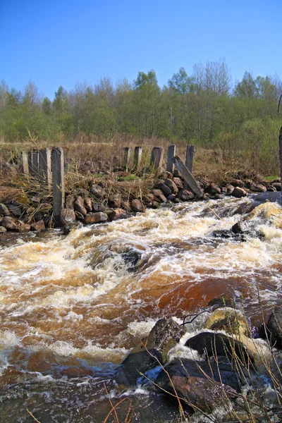 Речной поток на старой разрушенной плотине — стоковое фото