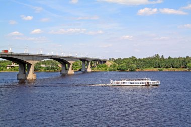 Small promenade motor ship on big river near bridge clipart