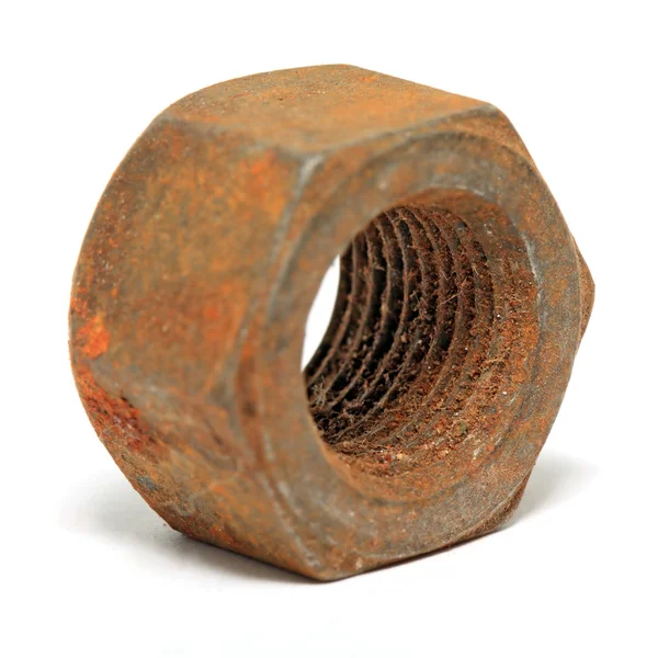Aging rusty nut on white background — Stockfoto