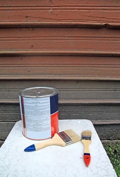 New paintbrush near dirty wall — Stock Photo, Image