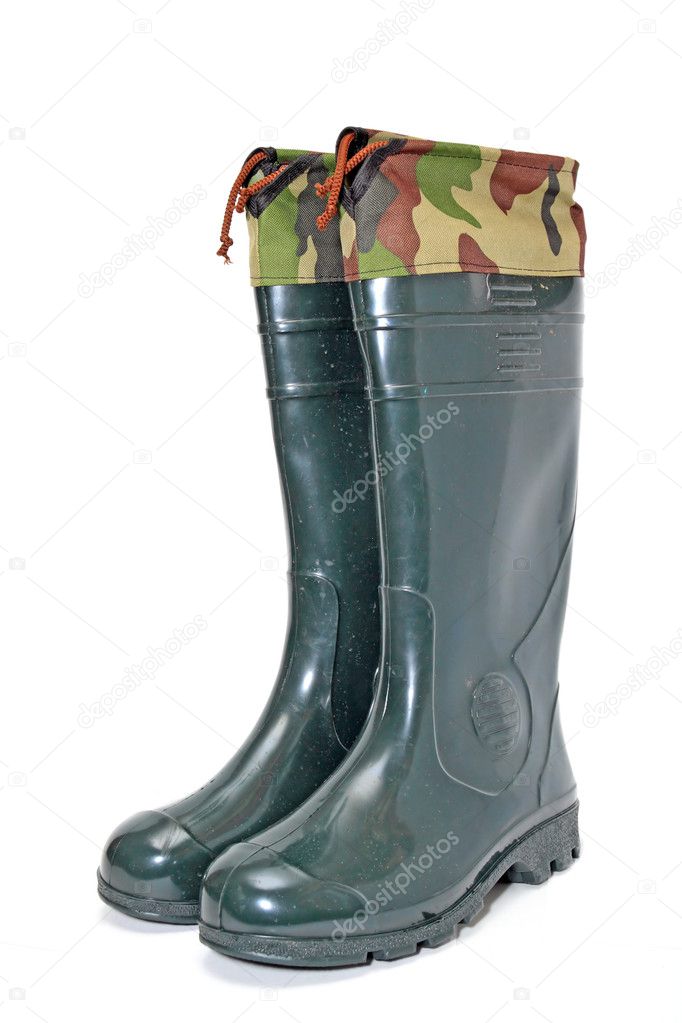 Green rubber boots on white background