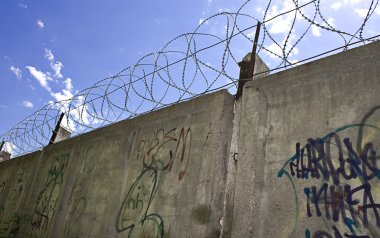 Barbed wire wall and blue sky clipart