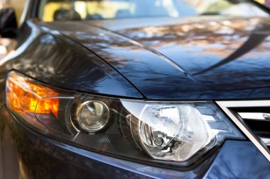 Aggressive looking, car headlight closeup clipart