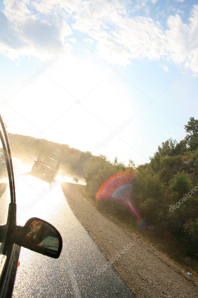 scene-after-rain-with-car-and-sun-opposite-stock-photo-2happy-8211162