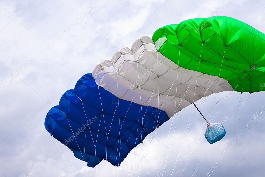 Skydiver flying in bright blue sky.