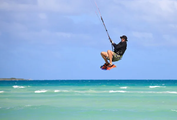 Mann im Flug über Wasser. Kitesurfen an der kubanischen Küste. — Stockfoto