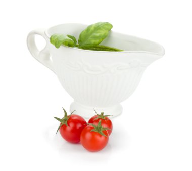 Three cherry tomatoes and pesto sauce clipart