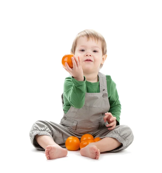 Baby with oranges — Stock Photo, Image
