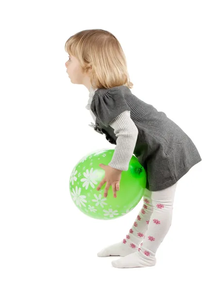 Baby girl with a green balloon — Stock Photo, Image