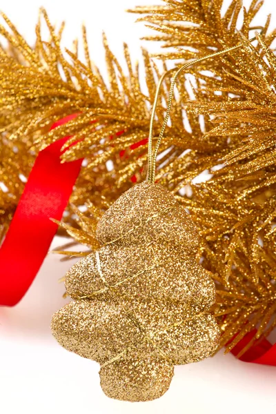 Golden christmas tree toy on golden fir-tree branch — Stock Photo, Image