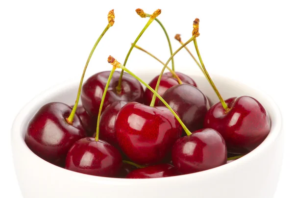 Red ripe cherries in a bowl on white background — Stock Photo, Image