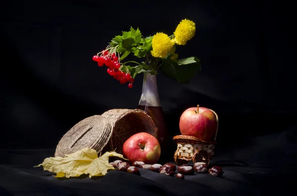 Still life with autumn fruits and flowers on black background — Stock Photo, Image