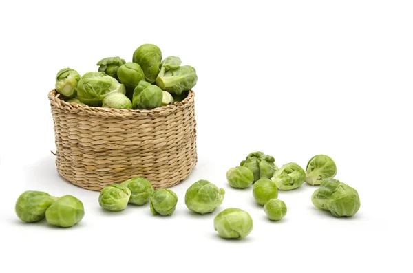 stock image Wicker basket with Brussels sprouts isolated on white background