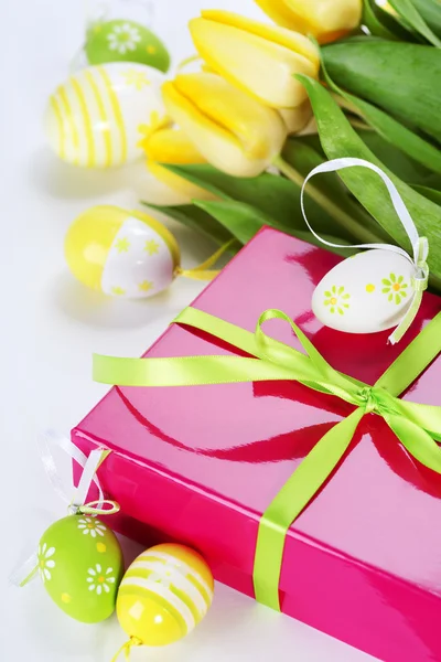 Easter eggs with yellow tulip flowers and gift box — Stock Photo, Image