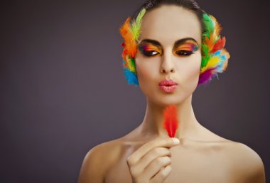 Beautiful young female face with bright fashion multicolored make-up &