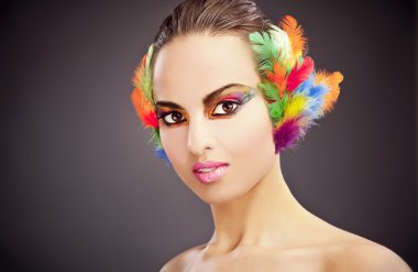 Beautiful young female face with bright fashion multicolored make-up &