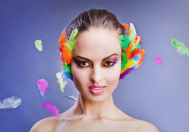 Beautiful young female face with bright fashion multicolored make-up &